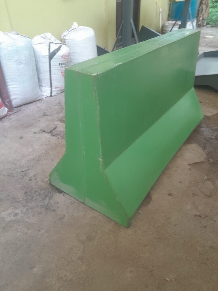 Green curb-v barrier, potentially for traffic control or construction site safety.